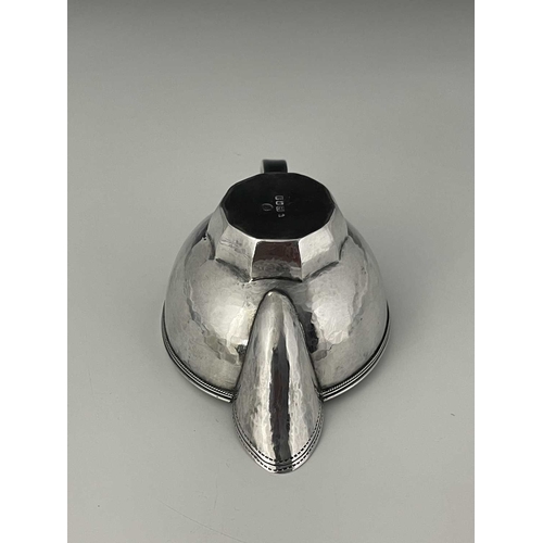 111 - Edward Spencer for Artificers Guild, an Arts and Crafts silver sauce boat, London 1932, planished ov... 