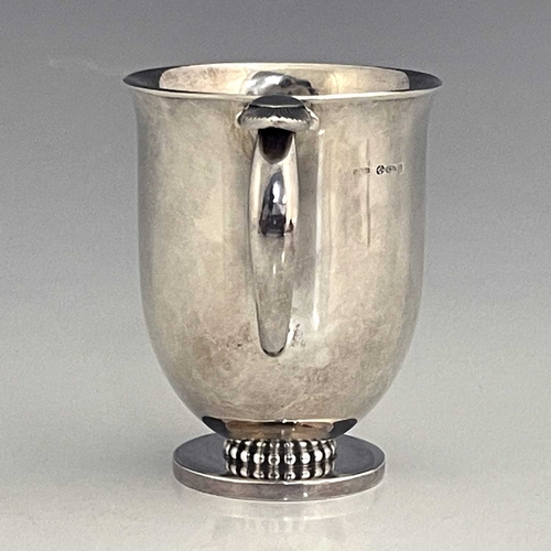 118 - Gundorph Albertus for Georg Jensen, a Cactus pattern silver mug, model 777, import marks London 1961... 