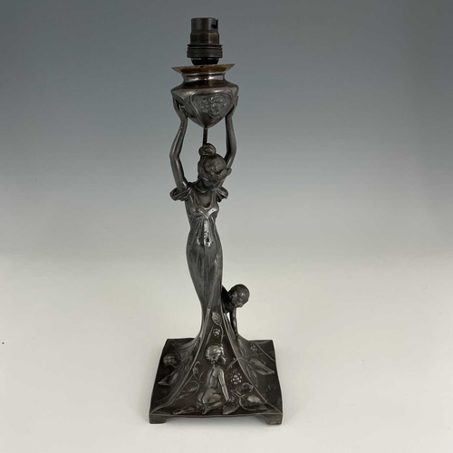 139 - WMF, a Jugendstil silver plated figural table lamp, the square sweeping base modelled in relief with... 