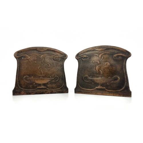 157 - A pair of Arts and Crafts copper bookends, repousse embossed and planished with stylised Roman oil l... 