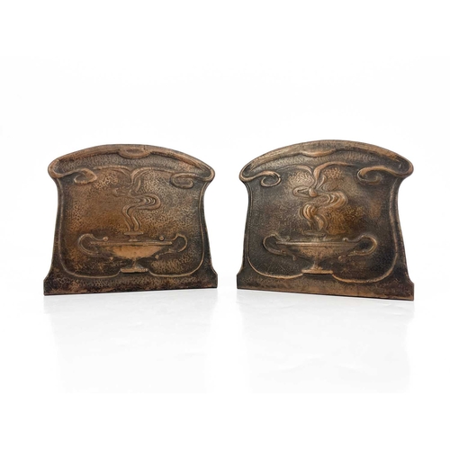 157 - A pair of Arts and Crafts copper bookends, repousse embossed and planished with stylised Roman oil l... 