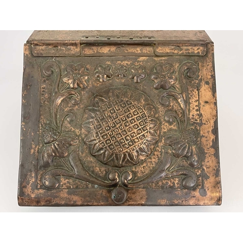 158 - John Pearson (attributed) an Arts and Crafts copper clad coal scuttle, the hinged lid repousse embos... 