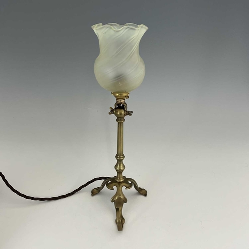 168 - An Arts and Crafts brass Pullman type lamp, with vaseline glass shade, three foliate legs, one with ... 