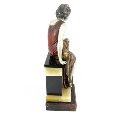 178 - An Art Deco patinated art metal figure group, circa 1930, modelled as a woman sitting on a plinth wi... 