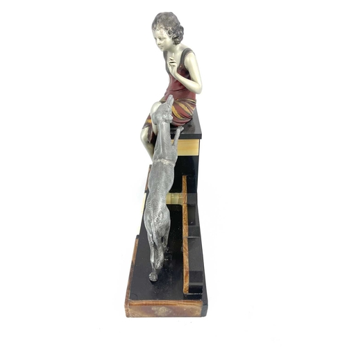 178 - An Art Deco patinated art metal figure group, circa 1930, modelled as a woman sitting on a plinth wi... 