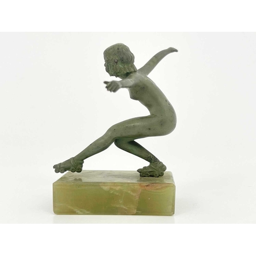 180 - An Art Deco bronze figure, circa 1925, modelled as a nude woman roller skating, verdigris patination... 