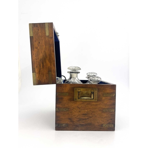 198 - A 19th Century oak and brass bound decanter box, flush side handles, blue velvet fitted interior con... 