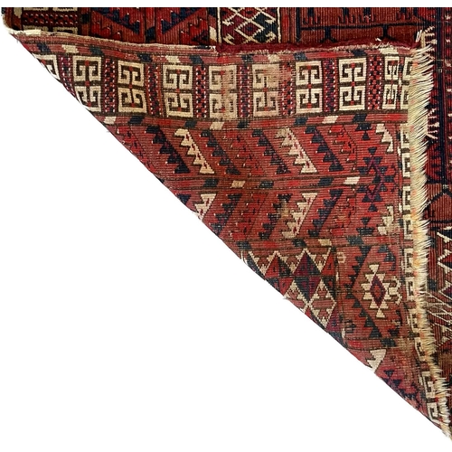 208 - Tekke Engsi rug, early 20th century, the rust red field with cruciform motif, within rust red serrat... 