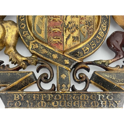 214 - A cast iron and enamelled Royal Warrant, for Queen Mary, circa 1920, with coat or arms and supporter... 