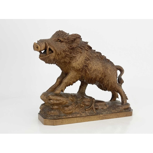 221 - A Black Forest carved wood figure of a boar, 19th century, realistically modelled on a rocky outcrop... 