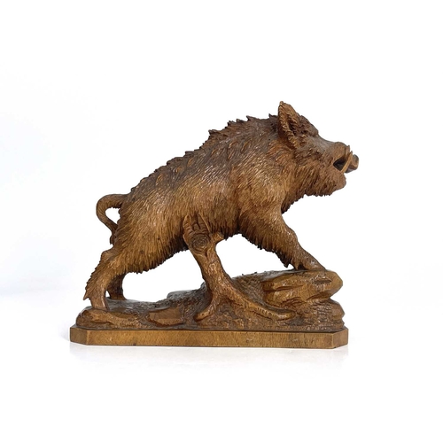 221 - A Black Forest carved wood figure of a boar, 19th century, realistically modelled on a rocky outcrop... 