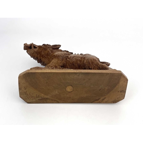 221 - A Black Forest carved wood figure of a boar, 19th century, realistically modelled on a rocky outcrop... 