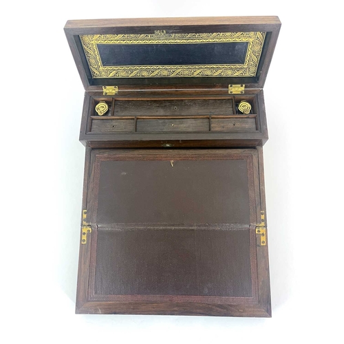 225 - A Regency rosewood writing compendium, circa 1820, brass inlaid, caddy top with a concealed velvet l... 