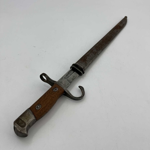 255 - A Japanese Type 30 sword bayonet, two piece wooden grip, housed in steel scabbard, Nagoya Army Arsen... 