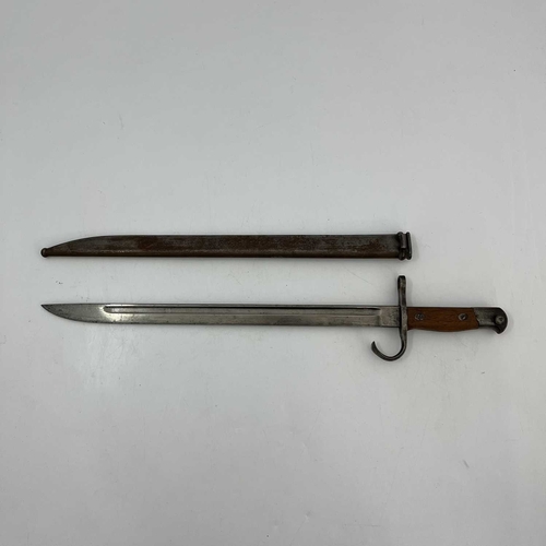 255 - A Japanese Type 30 sword bayonet, two piece wooden grip, housed in steel scabbard, Nagoya Army Arsen... 