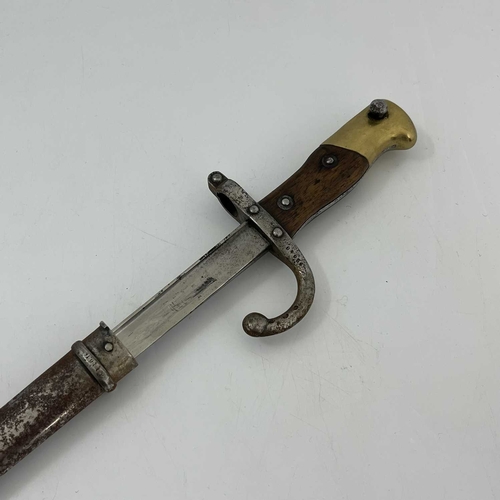 258 - A French M1874 Gras sword bayonet, two piece wooden grip, housed in steel scabbard, foundry marks to... 