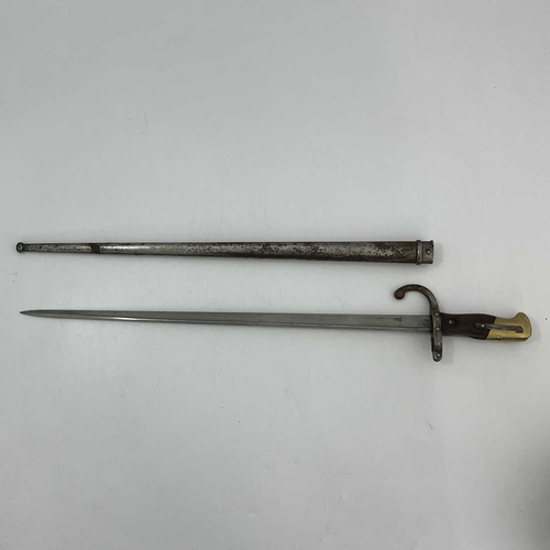 258 - A French M1874 Gras sword bayonet, two piece wooden grip, housed in steel scabbard, foundry marks to... 