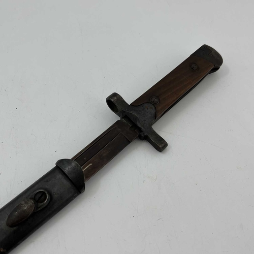 259 - An Italian M1938 Mannlicher-Carcano knife bayonet, two piece wooden grip, housed in blackened steel ... 