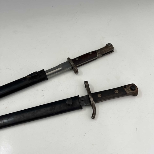 262 - Two bayonets, Finnish M1927 Mosin-Nagant sword bayonet by Fiskars, two piece wooden grip housed in s... 