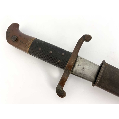 277 - A 19th century British Lancaster sword bayonet, two piece chequered and brass grip, housed in leathe... 