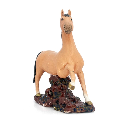 448 - A Chinese porcelain figure, 19th century, modelled as a figure of a colt, with black mane and tail, ... 