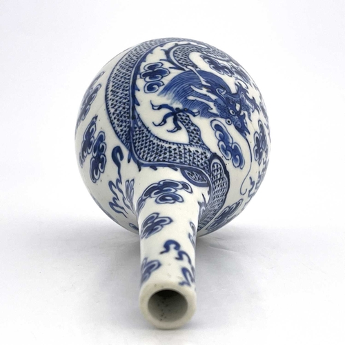 453 - A Chinese blue and white bottle vase, probably Kangxi, painted with dragons and flaming pearl amongs... 