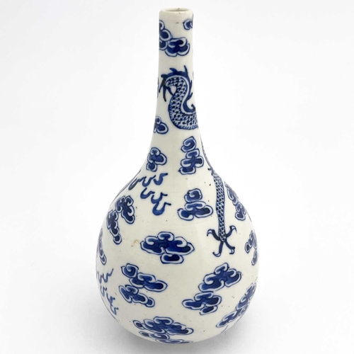 453 - A Chinese blue and white bottle vase, probably Kangxi, painted with dragons and flaming pearl amongs... 