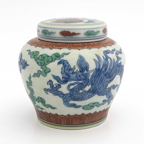 455 - A Chinese Doucai porcelain jar and cover, squat baluster form, painted with blue dragons within terr... 