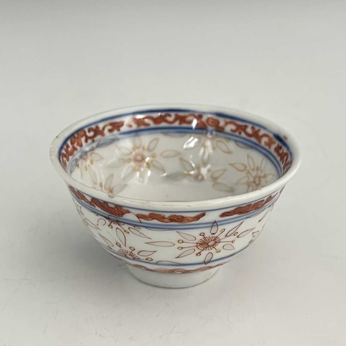 456 - A Chinese porcelain rice grain tea bowl, decorated in iron red with auspicious motifs and translucen... 