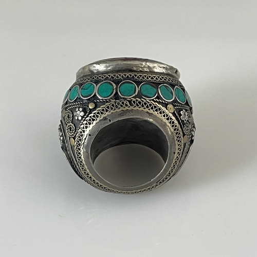 457 - A large Islamic ring of bulbous form, 19th Century, the wrought metalwork inlaid with turquoise ston... 