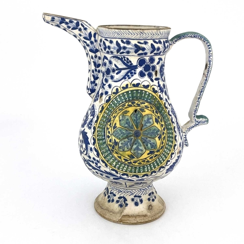 460 - A Turkish Ottoman pottery ewer, footed baluster form, relief moulded floral roundels within blue and... 