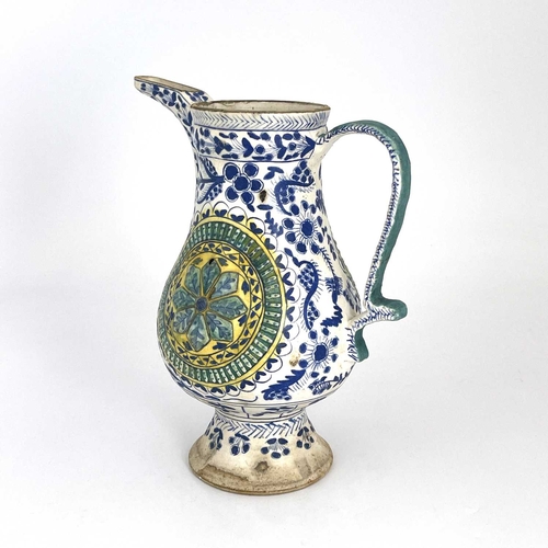 460 - A Turkish Ottoman pottery ewer, footed baluster form, relief moulded floral roundels within blue and... 