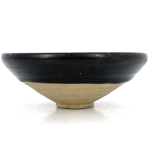 461 - A Chinese Jian type black glazed bowl, probably Southern Song dynasty, conical with dipped glaze, bu... 