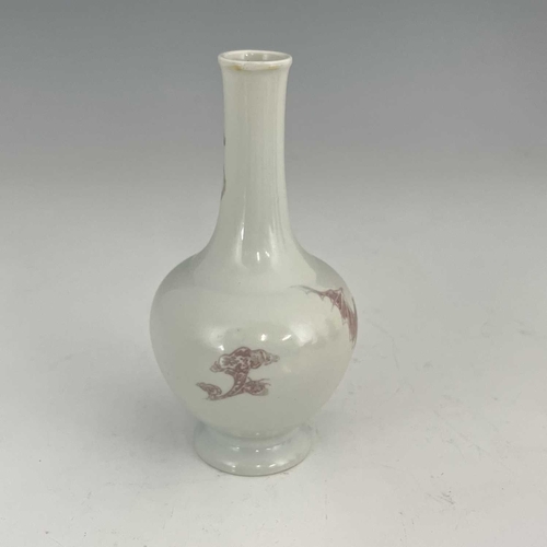 462 - A Chinese porcelain narrow-necked bottle vase, 19th Century, decorated in underglaze red with writhi... 