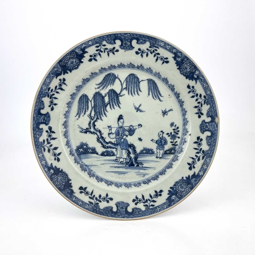 465 - A Chinese blue and white plate, 18th century, probably Qianlong, painted with a traveller and boy by... 