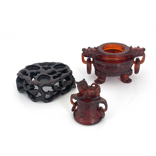 485 - A Chinese pressed cherry amber censer, ring handles and lid, modelled in low relief with foliate scr... 