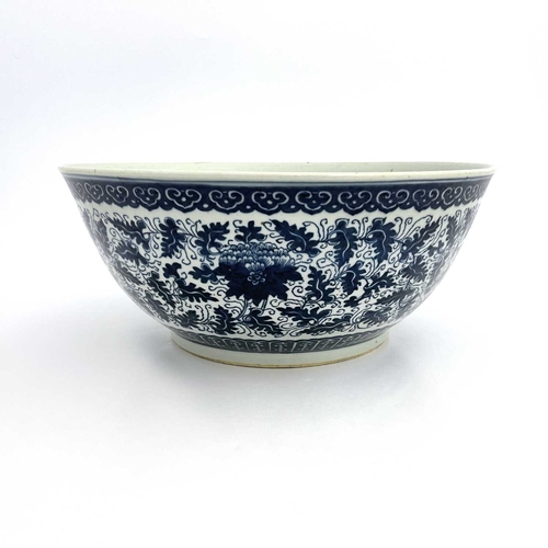 486 - A Chinese blue and white bowl, painted with lotus flowers and foliate scrolls between lappet and ruy... 