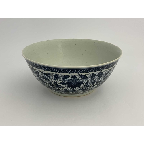 486 - A Chinese blue and white bowl, painted with lotus flowers and foliate scrolls between lappet and ruy... 