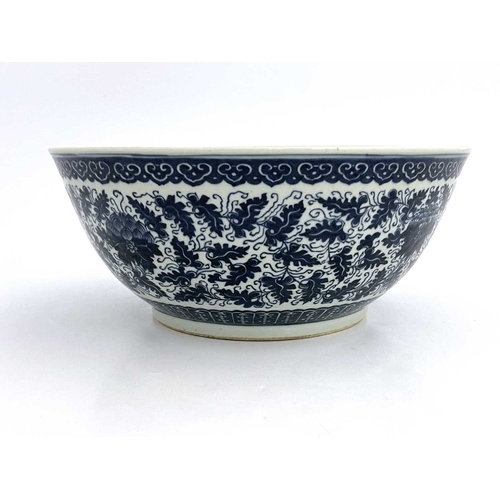 486 - A Chinese blue and white bowl, painted with lotus flowers and foliate scrolls between lappet and ruy... 