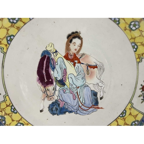 488 - A Chinese famille jaune dish, the central image of Wang Zhaojun in polychrome enamel within a yellow... 