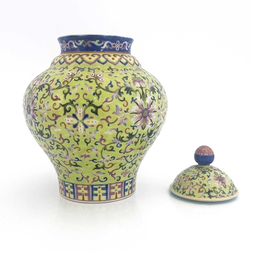 496 - A Chinese porcelain lime green lidded vase, 19th Century, of baluster form, intricately decorated wi... 