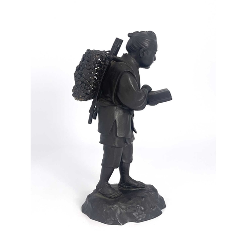 501 - A Japanese bronze figure, Meiji, modelled as a travelling man reading a book, 37cm high