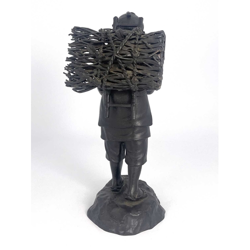 501 - A Japanese bronze figure, Meiji, modelled as a travelling man reading a book, 37cm high