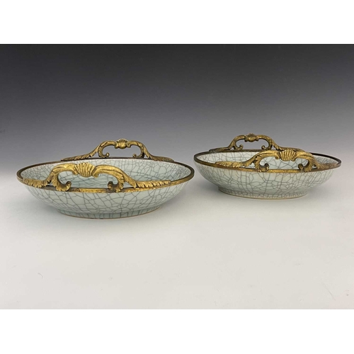 502 - A pair of Chinese celadon crackle-glazed bowls, circular form with cast gilt metal mounts, glazed sp... 