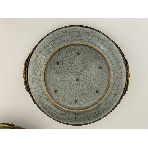 502 - A pair of Chinese celadon crackle-glazed bowls, circular form with cast gilt metal mounts, glazed sp... 