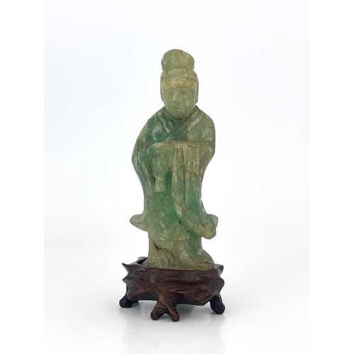 504 - A Chinese carved green quartz figural finial, 19th century or earlier, modelled as Guanyin, standing... 