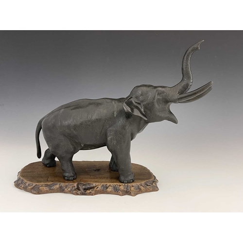 506 - A Japanese bronze figure of an elephant, Meiji period, modelled with trunk raised, cast seal marks, ... 