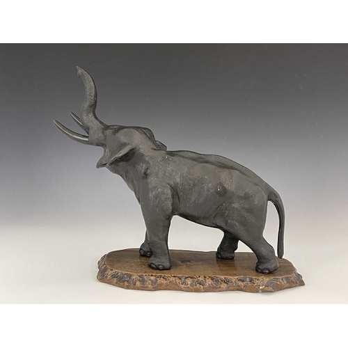 506 - A Japanese bronze figure of an elephant, Meiji period, modelled with trunk raised, cast seal marks, ... 