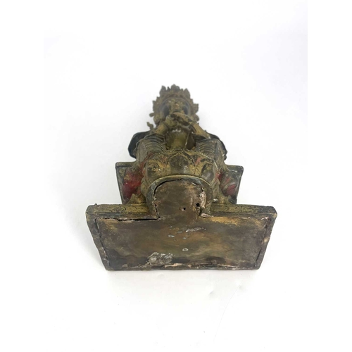 509 - An Oriental gilt bronze figure of Tara, modelled sitting on a plinth, highlighted in polychrome enam... 