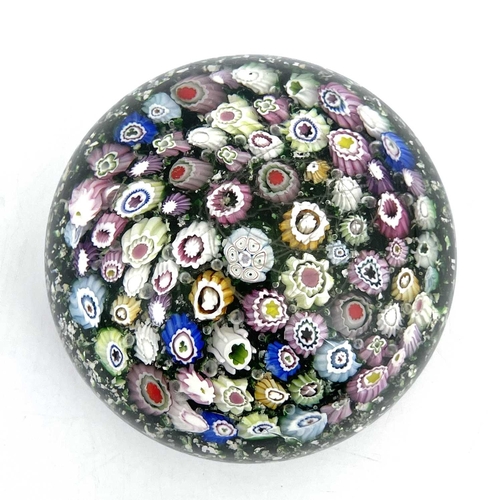 512 - Riedel, a random cane millefiori glass paperweight, late 19th century, mica gravel green ground with... 